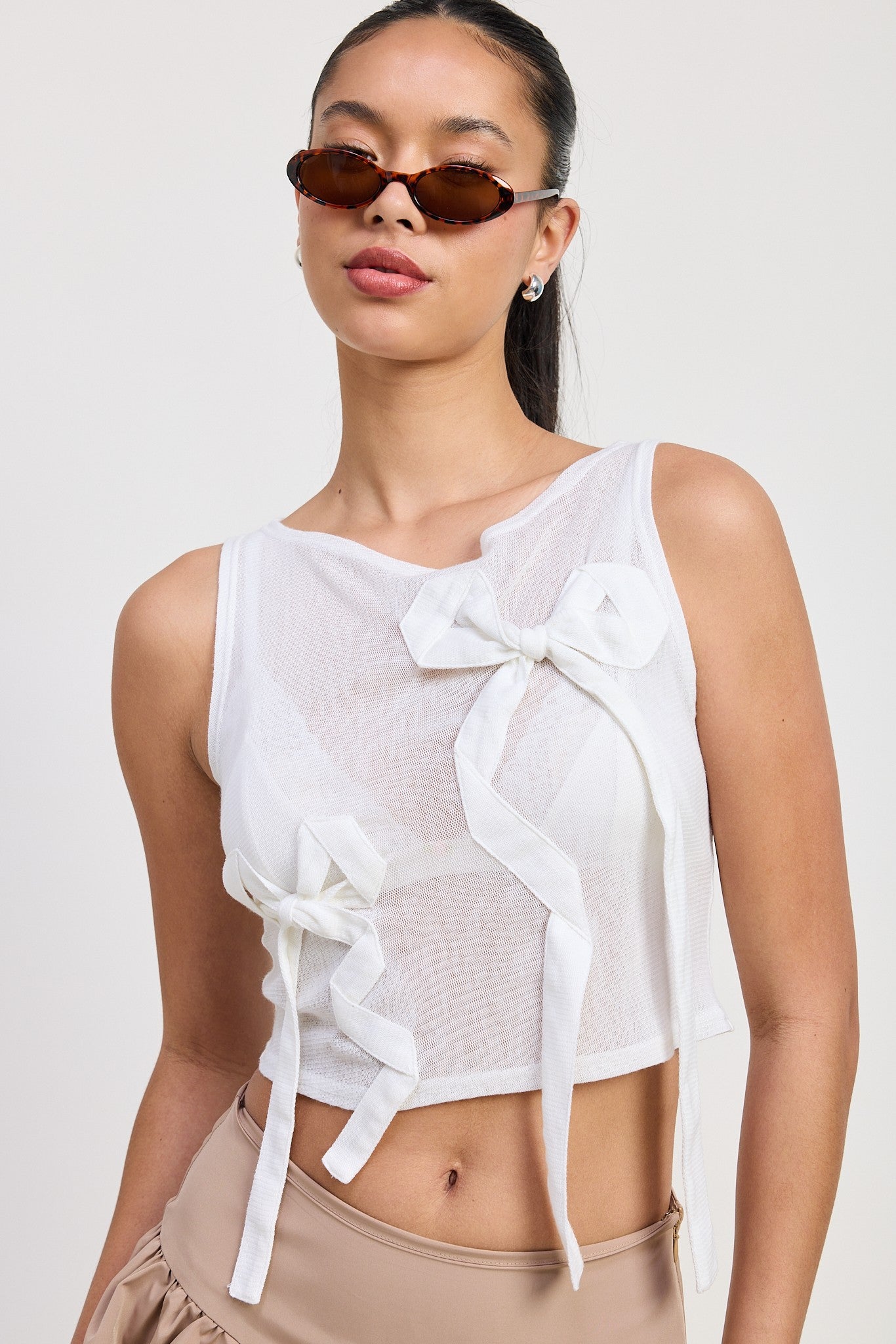 SLEEVELESS SHEER BOW TOP