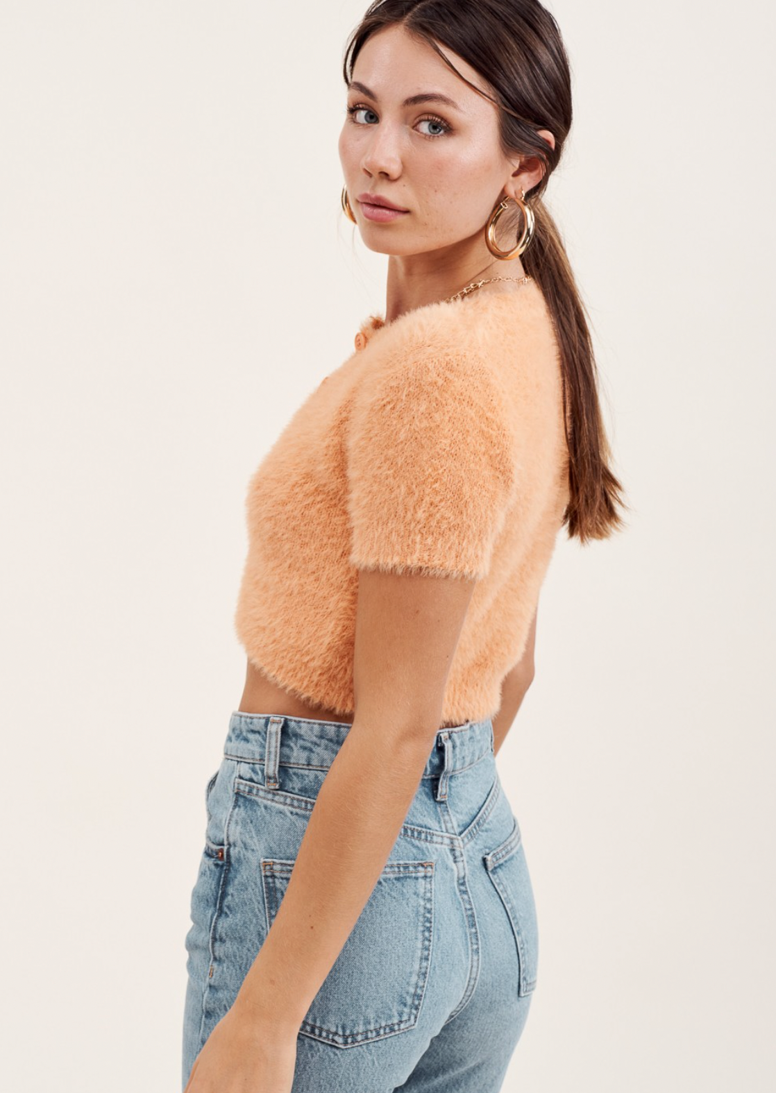 Soft fluffy & fuzzy knit slim fit cardigan top. Round neck with front buttons, cropped length hem.