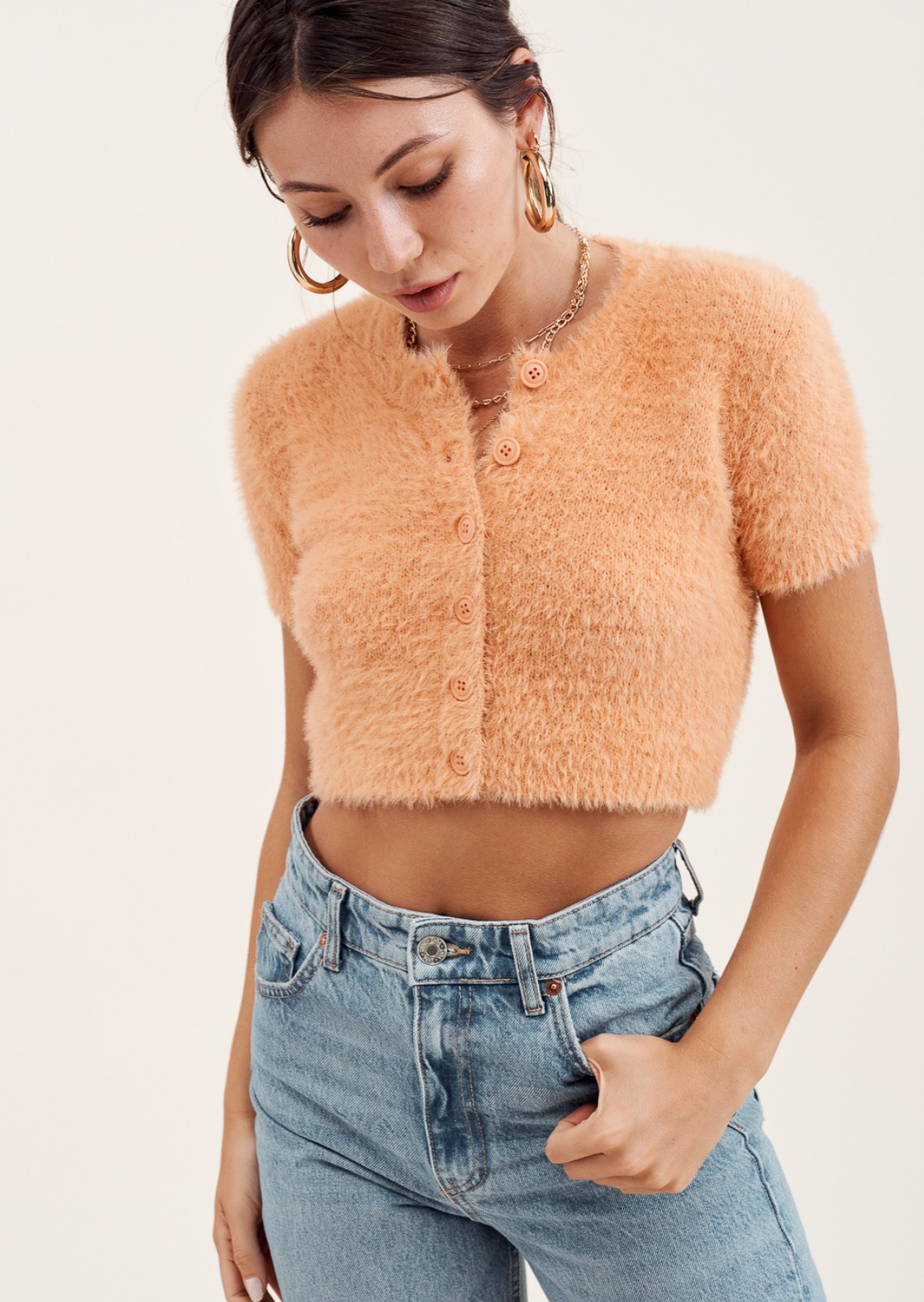 Soft fluffy & fuzzy knit slim fit cardigan top. Round neck with front buttons, cropped length hem.